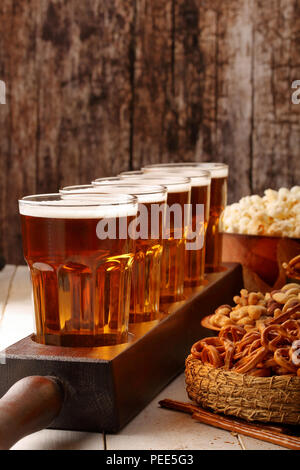 Beer row and snacks on wooden background football fan set Stock Photo