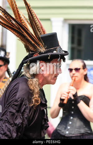 Traditional English folk dancer, man from the Wolf's head and Vixen Morris side. Wears black and top hat with feathers, characterful face. Portrait. Stock Photo