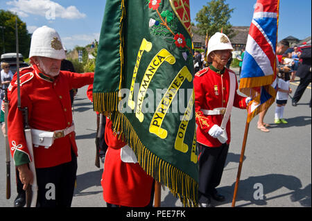 World War One living history reenactors soldiers of the South Wales Borderers 24th Regiment of Foot with the regimental colours at Hay-on-Wye Powys Wales UK Stock Photo