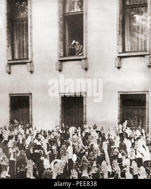 Germans cheering Hitler on hearing the news of his election as chancellor in 1933.  Adolf Hitler, 1889 – 1945.  German politician, demagogue, Pan-German revolutionary, leader of the Nazi Party, Chancellor of Germany (1933-1945) and Führer ('Leader') of Nazi Germany (1934 - 1945).  From These Tremendous Years, published 1938. Stock Photo