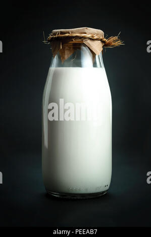A bottle of fresh milk isolated on a black background closeup Stock Photo