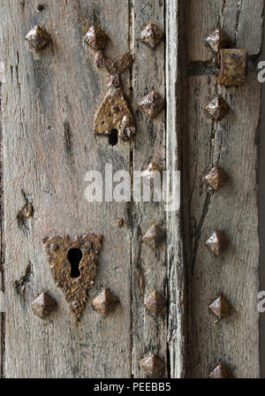 old rusty iron lock on a wooden door Stock Photo