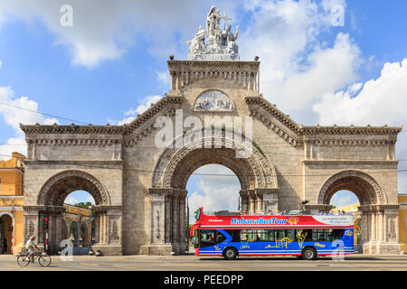 Main gate entrance  to the famous Colon Cemetry with tourist tour bus passing, Cementerio Cristóbal Colón, Vedado, Havana, Cuba Stock Photo