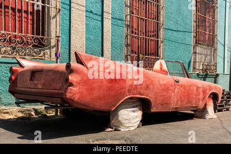 Old American classic car wreck, chassis being restored and re-painted in Havana, Cuba Stock Photo