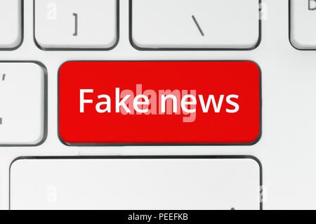 Fake News concept. Red button with Fake News words on the keyboard close-up Stock Photo