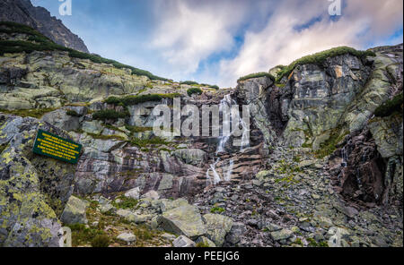 Skok Waterfall in Mountains on Cloudy Day. Mlynicka Valley, High Tatra, Slovakia. Stock Photo