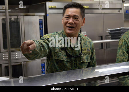 Col. Teo Wee Hong (center), chief of staff, 6th Division, Singapore army, inspects the dinning facility during a tour at the 298th Regiment's Multi-Functional Training Unit (MFTU) located at Bellows Air Force Station, Hawaii, on Jan. 21, 2016. The 3rd Brigade Combat Team, 25th Infantry Division, hosted the six officer delegation at Schofield Barracks, Hawaii, to discuss preparations for Tiger Balm 16 exercise slated to happen throughout Hawaii this summer. (Photo by Staff Sgt. Armando R. Limon, 3rd Brigade Combat Team, 25th Infantry Division) Stock Photo