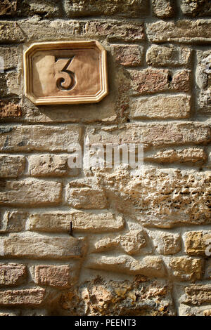 Old house number 3 on veeeeery old house maded from bricks and love Stock Photo