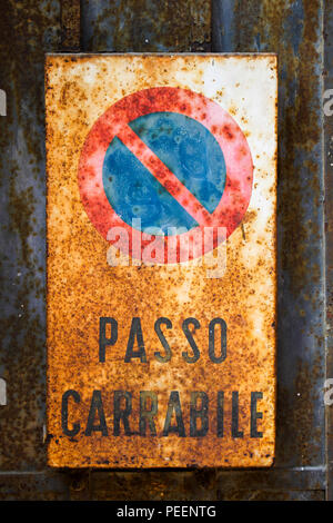 Old and very rusty No Parking sign with italian words on it cause it is italian sign in italian city, logical! Stock Photo