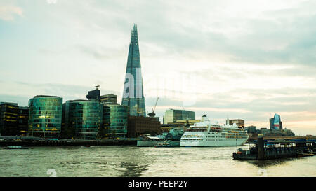 Cruise Ship on the River Thames with The Shard (of Glass) skyscraper & HMS Belfast museum ship, London. Stock Photo