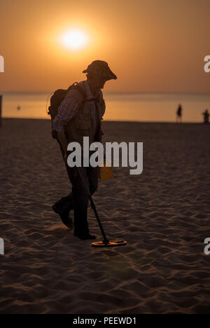 Jurmala, Latvia-July 30, 2014: Man using a metal detector on the beach. Concept photo of searching for money, gold, etc. On july 30,2014 Stock Photo