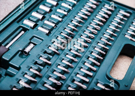 Set of metal heads for screwdriver in green box Stock Photo