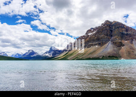 Bow Lake and Crowfoot Mountain in Banff National Park, with Crowfoot Glacier in the background. Located at the base of Bow Summit, the lake is fed by  Stock Photo