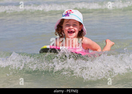 Happy girl on body board Stock Photo
