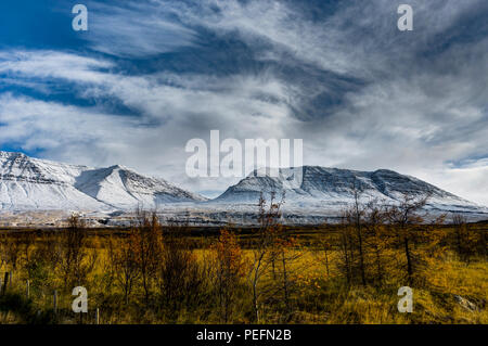 Winter Christmas landscape with trees and mountains. Christmas landscape on a sunny morning with blue sky and clouds and fresh snow. Photo taken in Ic Stock Photo