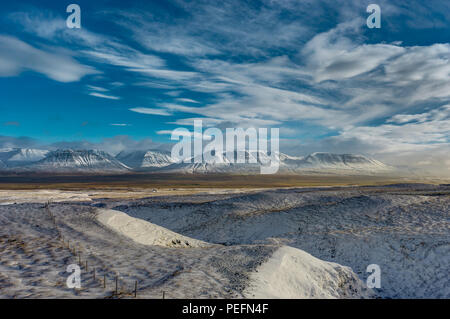 Winter Christmas landscape with trees and mountains. Christmas landscape on a sunny morning with blue sky and clouds and fresh snow. Photo taken in Ic Stock Photo