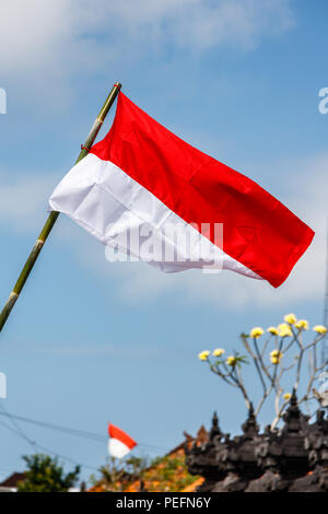 Flags at the streets of Bali before celebration on Indonesian Independence day. Bali, Indonesia. Vertical image. Stock Photo