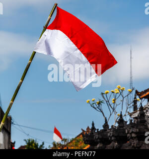 Flags at the streets of Bali before celebration on Indonesian Independence day. Bali, Indonesia. Vertical image. Stock Photo
