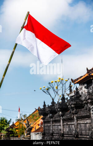 Flags at the streets of Bali before celebration on Indonesian Independence day. Bali, Indonesia. Vertical image. Stock Photo