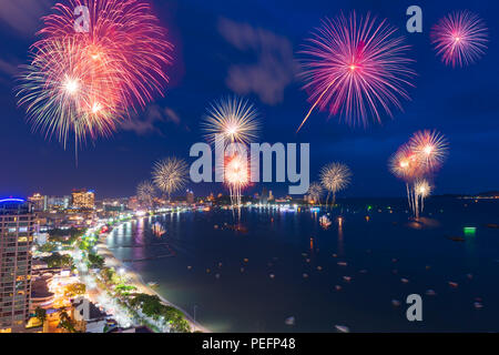 Fantastic and colorful fireworks over the sea and city with blue twilight sky background and city view in new year celebration night at Pattaya, Chon  Stock Photo