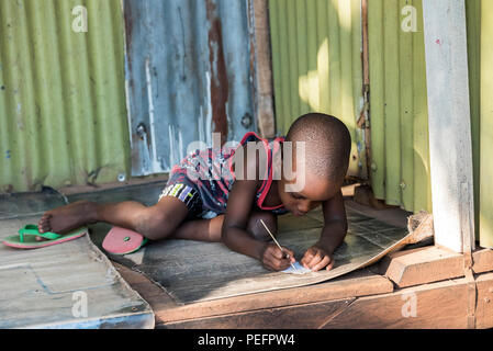 Uganda - Kampala kid studying Stock Photo