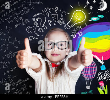 Ideas, discovery and creativity education concept with little genius girl on school chalk board background with science and arts elements and lightbul Stock Photo