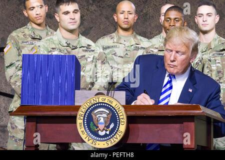 President Donald J. Trump signs the National Defense Authorization Act of 2019 at Fort Drum, New York, on August 13. The act authorizes a budget that supports the Army's Vision, resources our modernization initiatives and priorities, continue to increase the readiness and lethality of the force, and postures the Army to meet the requirements of the National Defense Strategy. (U.S. Army photo by Sgt. Thomas Scaggs) 180813-A-TZ475-085