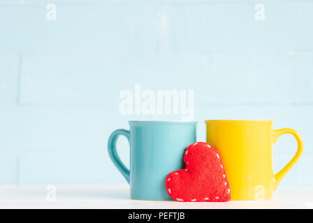 Coffee cups on wooden table with handmade red heart. Friendship day celebration background Stock Photo