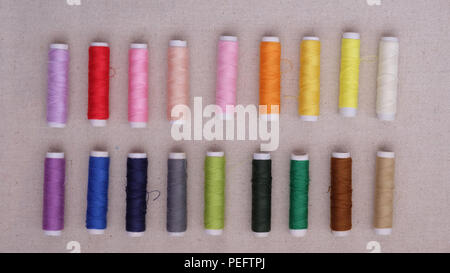 Colorful thread rolls arranged into two rows Stock Photo