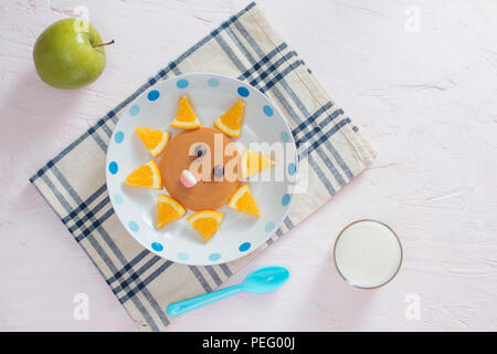 Funny pancakes with orange for kids breakfast Stock Photo
