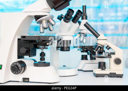 Four microscopes of different designs in the laboratory Stock Photo