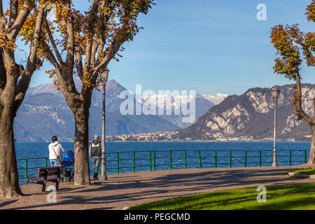 LECCO, ITALY/EUROPE - OCTOBER 29 : People walking along the promenade at Lecco by Lake Como  in Italy on October 29, 2010. Two unidentified people Stock Photo