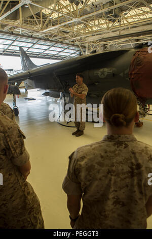 U.S. Marine Corps 1st Lt. Matthew Lake, center, gives a brief about the capabilities and limitations of the AV-8B Harrier during a Squadron Intelligence Training Certification Course (SITCC) to intelligence specialists at Marine Corps Air Station Cherry Point, N.C., Aug. 19, 2015. The SITCC is a four week course designed for junior intelligence analysts providing in-depth aviation intelligence information to better support squadron commanders and pilots.. (U.S. Marine Corps photo by Pfc. Jered T. Stone/Released) Stock Photo