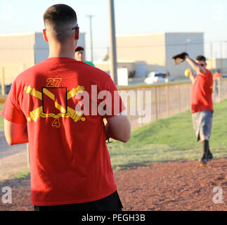 Members of the Fort Bliss Commander’s Cup championship softball team assigned to Headquarters and Headquarters Battery, 4th Battalion, 27th Field Artillery Regiment, 1st Armored Division Artillery, warm up before their semi-final post championship game at the Omar Bradley Field at Fort Bliss, Texas, Aug. 12. The 4-27 softball team competed against over 50 post and division softball teams. (Army photo by Spc. Moniqua S. Woods/Released) Stock Photo