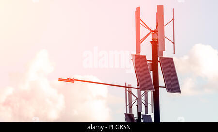 Wind turbine with solar panels on pillar against sky background. Public city light with solar panel powered on blue sky with clouds Stock Photo