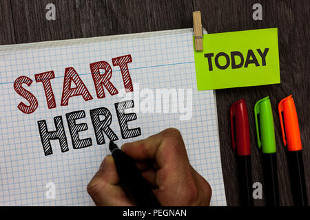 Conceptual hand writing showing Start Here. Business photo text telling someone this is beginning point to go from to destination Man holding marker n Stock Photo