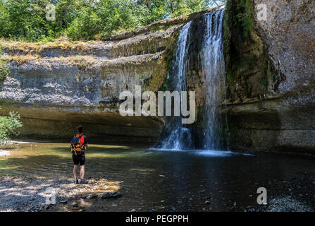 Hiker and the Saut del la Forge Waterfall, Cascades du Herisson, Jura, France, EU. Stock Photo