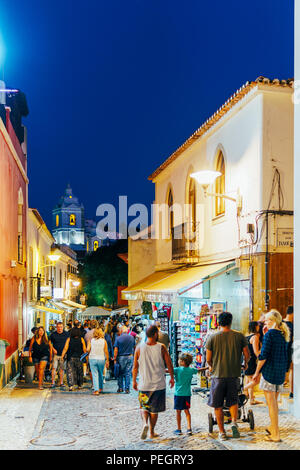 LAGOS, PORTUGAL - AUGUST 31, 2017: Tourists Walking Along Beautiful Architecture In Downtown City Of Lagos In Portugal At Night Stock Photo