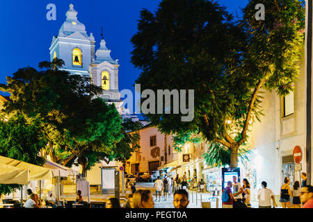 LAGOS, PORTUGAL - AUGUST 31, 2017: Tourists Walking Along Beautiful Architecture In Downtown City Of Lagos In Portugal At Night Stock Photo