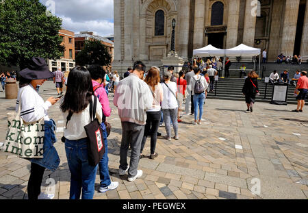 tourists queuing to enter st paul's cathedral, london, england Stock Photo