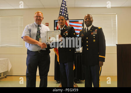 Spc. Jhan Moreno (center) received his certificate of citizenship from Eric Holman (left), supervisory immigration services officer with U.S. Citizenship and Immigration Services, with 3rd Cavalry Regiment commander Col. Kevin Admiral at a naturalization ceremony on Fort Hood Aug. 18, 2015. Stock Photo