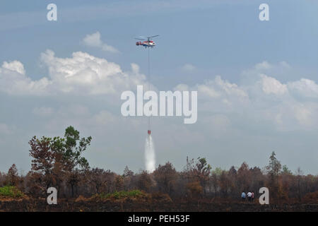 Pekanbaru, RIAU, INDONESIA. 15th Aug, 2018. Helicopters of Indonesian National Disaster Management Agency (BNPB) are seen fighting extinguished peatlands fires in Kampar District, Riau Province, Indonesia.According to Indonesia's Meteorology, Climatology and Geophysics Agency (BMKG), hotspots were also observed in other provinces in Sumatra such as in Lampung 1 hotspot, in North Sumatra 14 hotspots, in West Sumatra 13 hotspots and 2 hotspots in South Sumatra. Peatlands fires that occurred in Sumatra due to the dry season. Credit: ZUMA Press, Inc./Alamy Live News Stock Photo