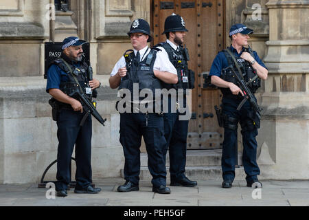 London, UK. 15th Aug, 2018. Armed policemen stand guard outside the Houses of Parliament in London, Britain, on Aug. 15, 2018, a day after a man was arrested on suspicion of terror offences after a car crashed into security barriers outside the Houses of Parliament. Credit: Ray Tang/Xinhua/Alamy Live News Stock Photo