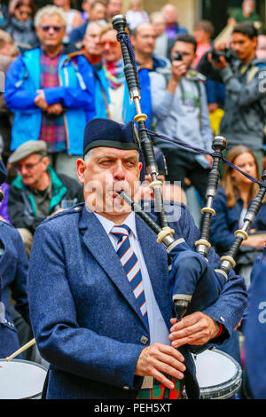 Glasgow, UK. 15th Aug 2018. Street performances continue in Buchanan Street, Glasgow with more international pipe bands playing near the Donald Dewar statue to entertain the public for free. The Pipe Band championships conclude on Saturday 18th August at Glasgow Green. Members of the Simon Fraser University Pipe Band from British Columbia, Canada Credit: Findlay/Alamy Live News Stock Photo