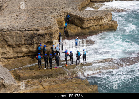 Coasteering group at Dancing Ledge, Jurassic Coast, Swanage, Dorset, England, UK, August 2018. Stock Photo