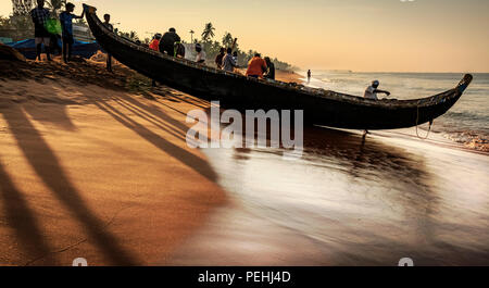 Fishing boat about to get into the water in Shankhumugham Stock Photo