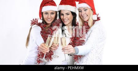 three young women in hats of Santa Claus with glasses of champa Stock Photo