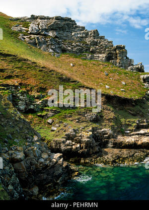 View NNW across Frenchman's Landing cove, Lundy Island, Devon, UK: Queen Mab's Grotto sea cave (centre L) & the propped granite slab mousetrap rear R. Stock Photo