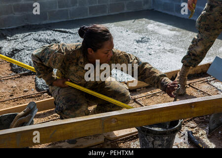Marines with Special Purpose Marine Air-Ground Task Force-Southern Command conduct construction operations at Luky Yabayak school in Puerto Lempira, Honduras, on August 21, 2015. Combat engineers clean and prepare concrete tools, ensuring safety and proper construction techniques. The temporary deployment across Honduras, El Salvador, Guatemala, and Belize focuses on partnership capacity, civil engagement, infrastructure support, and development projects while enhancing local relationships and technical skills of Marines and Sailors. Stock Photo