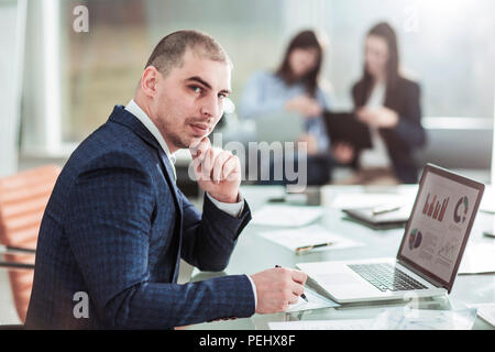 senior Manager at the workplace on the background of business team Stock Photo